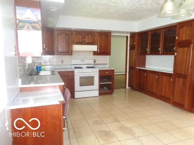 3253 W 34th St, Indianapolis, IN 46222 - kitchen with gas range gas stove, wall chimney range hood, tasteful backsplash, light countertops, and a textured ceiling