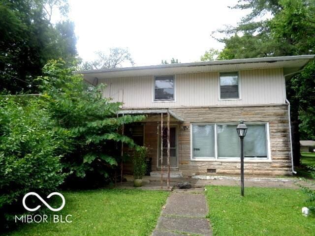 3253 W 34th St, Indianapolis, IN 46222 - view of front of home featuring stone siding and a front lawn