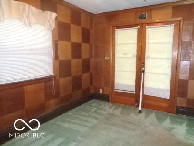 3253 W 34th St, Indianapolis, IN 46222 - carpeted spare room with french doors