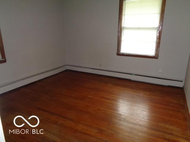 3253 W 34th St, Indianapolis, IN 46222 - unfurnished room with wood finished floors and a baseboard radiator