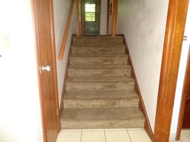 3253 W 34th St, Indianapolis, IN 46222 - stairway featuring carpet flooring and tile patterned floors