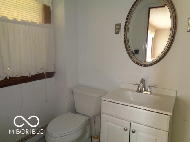 3253 W 34th St, Indianapolis, IN 46222 - half bathroom with vanity and toilet
