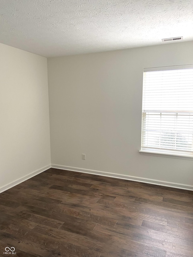 10477 Silver Ridge Cir, Fishers, IN 46038 - unfurnished room with dark wood-style floors and a textured ceiling