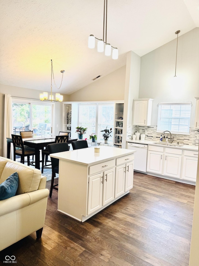 10477 Silver Ridge Cir, Fishers, IN 46038 - kitchen featuring dishwasher, dark wood finished floors, backsplash, and high vaulted ceiling