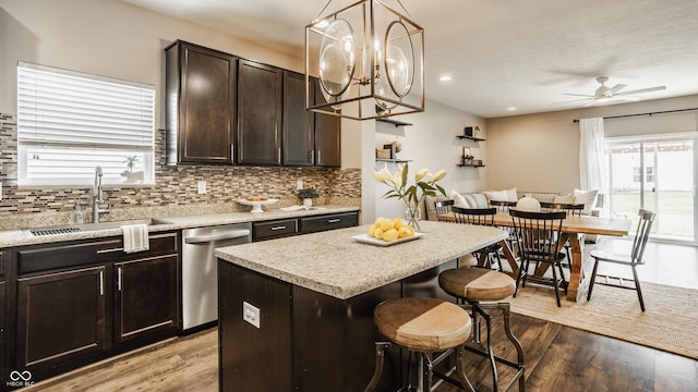 17183 Petersfield Ln, Westfield, IN 46074 - kitchen featuring dishwasher, a kitchen bar, backsplash, light wood-style floors, and ceiling fan