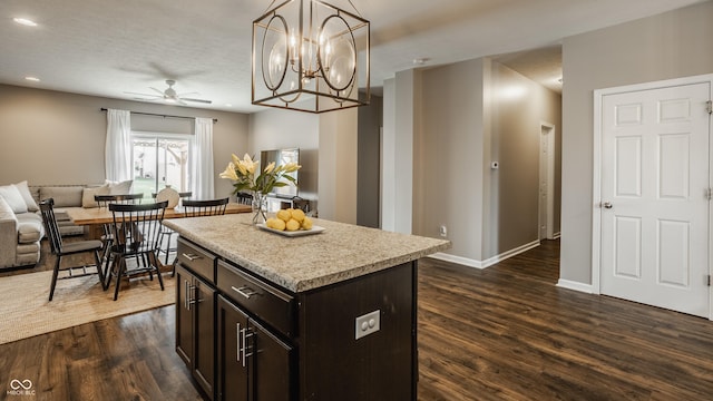 17183 Petersfield Ln, Westfield, IN 46074 - kitchen featuring open floor plan, ceiling fan, dark wood-type flooring, light countertops, and dark brown cabinetry