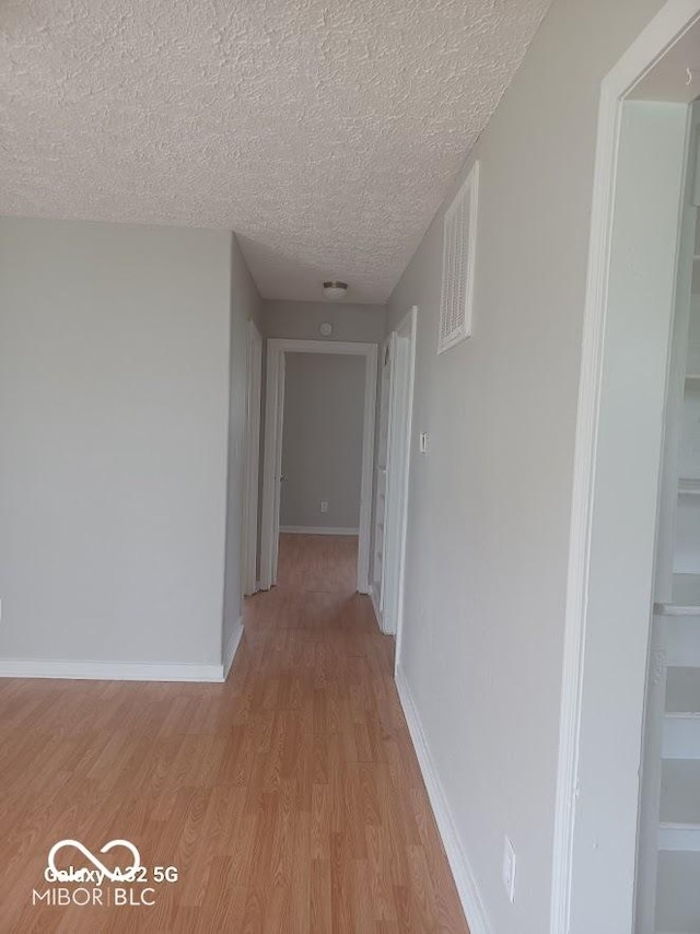 2138 Admiral Dr, Indianapolis, IN 46219 - corridor with a textured ceiling and light wood-style flooring