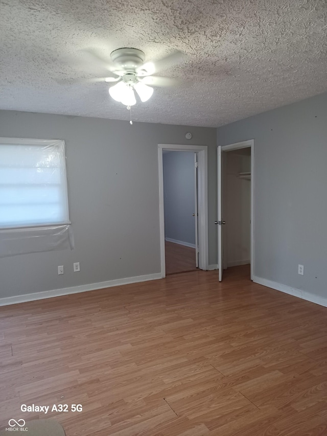 2138 Admiral Dr, Indianapolis, IN 46219 - unfurnished room with light wood finished floors, a ceiling fan, and a textured ceiling