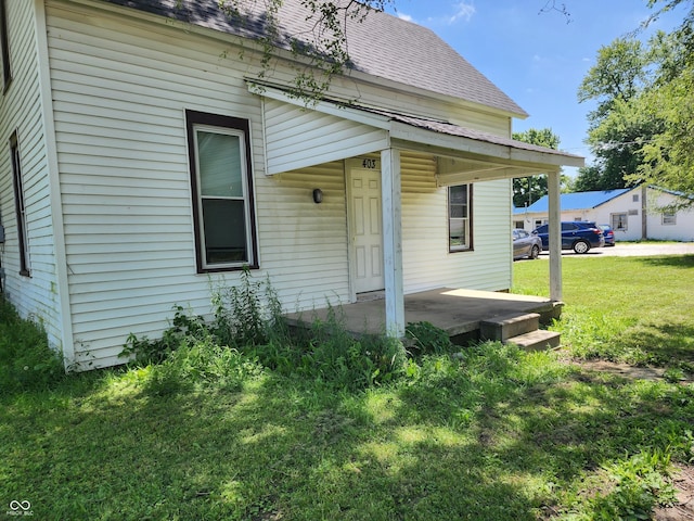 403 N Main St, Linden, IN 47955 - rear view of house featuring a shingled roof, a lawn, and a porch
