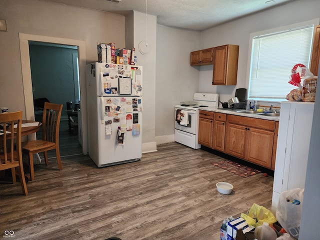 403 N Main St, Linden, IN 47955 - kitchen featuring white appliances, dark wood finished floors, brown cabinetry, and light countertops