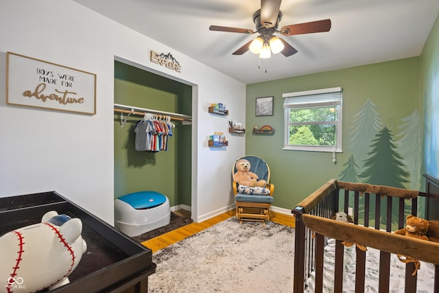 1302 N Furman Ave, Indianapolis, IN 46214 - bedroom with wood finished floors, a crib, a closet, and ceiling fan
