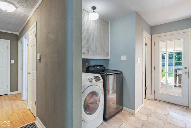 1302 N Furman Ave, Indianapolis, IN 46214 - laundry area featuring washer and clothes dryer, cabinet space, and ornamental molding