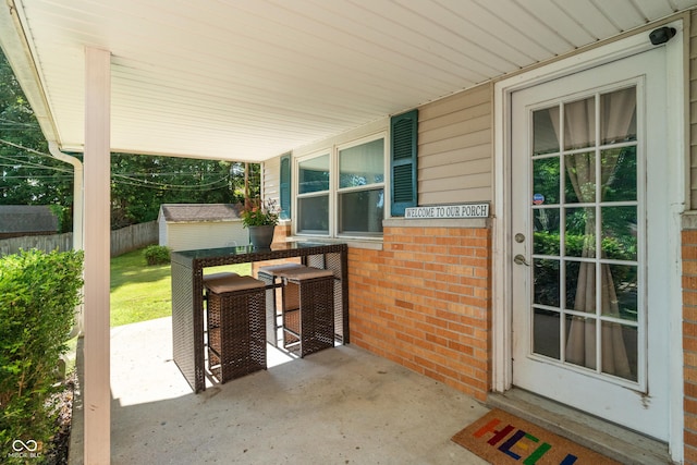 1302 N Furman Ave, Indianapolis, IN 46214 - covered porch featuring a storage unit