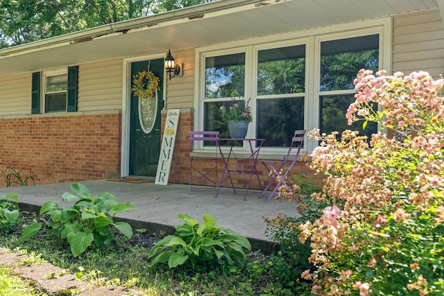 1302 N Furman Ave, Indianapolis, IN 46214 - doorway to property featuring brick siding and covered porch
