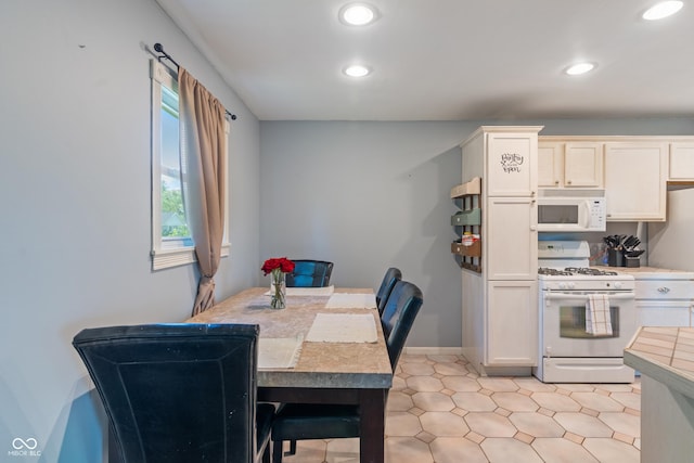 1302 N Furman Ave, Indianapolis, IN 46214 - kitchen with white appliances, recessed lighting, and light countertops