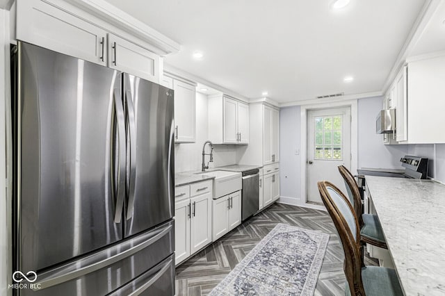 777 Sycamore St, Westfield, IN 46074 - kitchen featuring appliances with stainless steel finishes, white cabinetry, recessed lighting, and light stone countertops