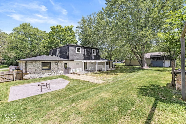 777 Sycamore St, Westfield, IN 46074 - rear view of house with a patio area, stone siding, a shingled roof, and mansard roof