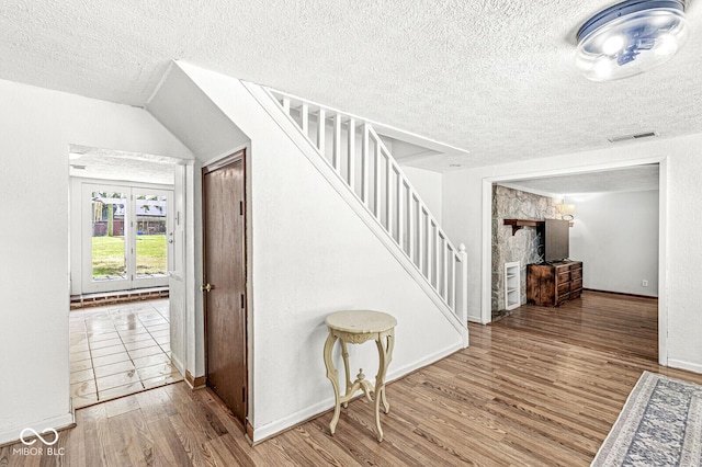777 Sycamore St, Westfield, IN 46074 - stairway featuring a textured ceiling and wood finished floors