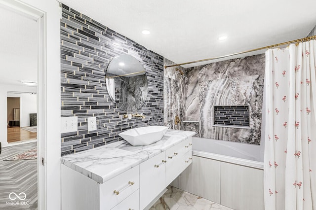 777 Sycamore St, Westfield, IN 46074 - full bathroom with vanity, shower / tub combo with curtain, decorative backsplash, marble look tile flooring, and recessed lighting
