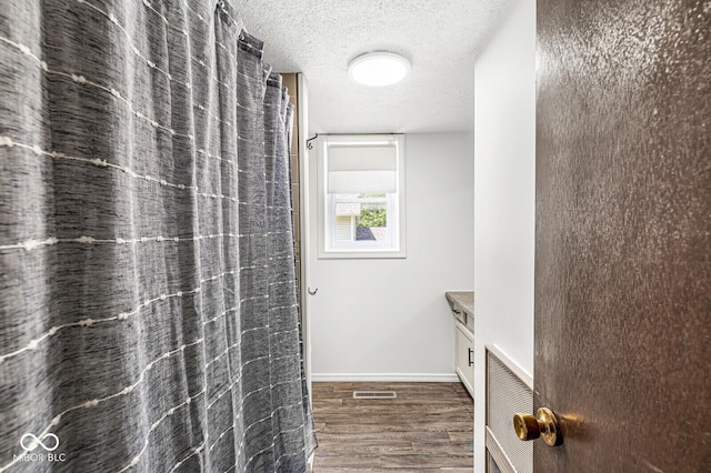 777 Sycamore St, Westfield, IN 46074 - full bathroom featuring wood finished floors, vanity, a textured ceiling, and a shower with shower curtain