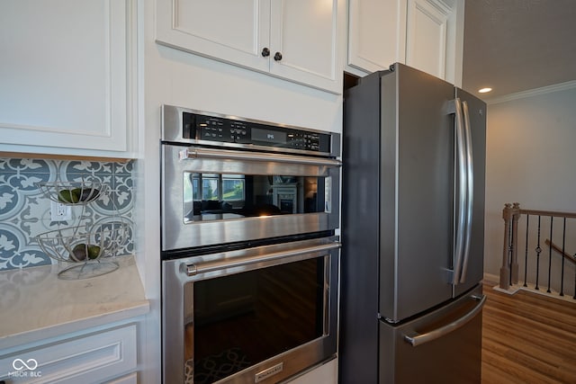 16235 Natures Way, Westfield, IN 46074 - kitchen with stainless steel appliances, white cabinets, light stone counters, dark wood-style floors, and decorative backsplash