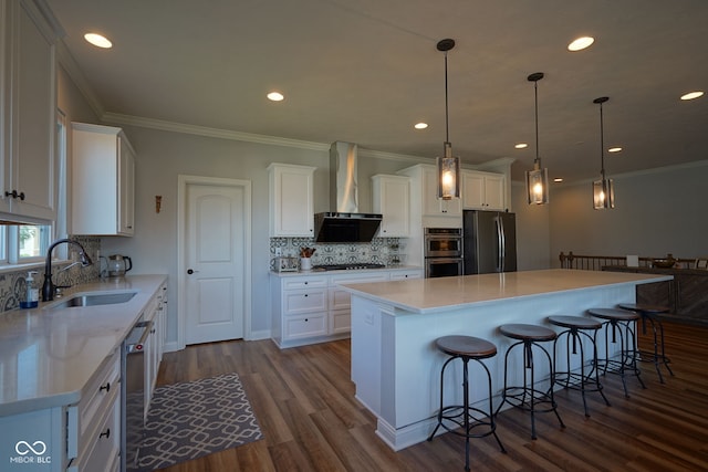 16235 Natures Way, Westfield, IN 46074 - kitchen with wall chimney range hood, appliances with stainless steel finishes, white cabinetry, dark wood finished floors, and a kitchen breakfast bar