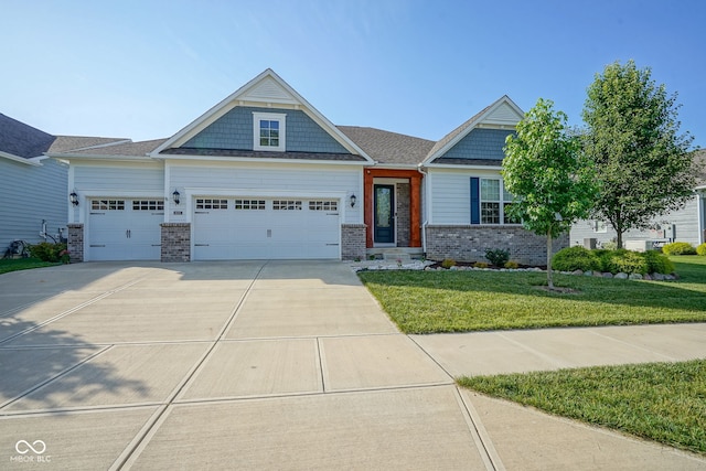 16235 Natures Way, Westfield, IN 46074 - craftsman house with a garage, brick siding, a front lawn, and driveway