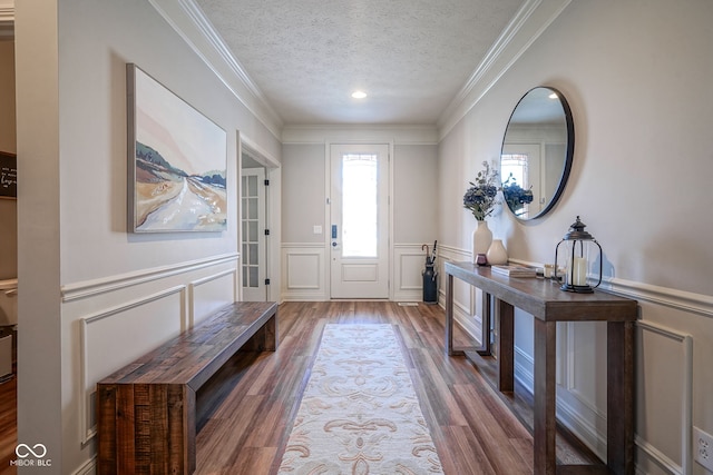 16235 Natures Way, Westfield, IN 46074 - foyer featuring a decorative wall, wood finished floors, a textured ceiling, ornamental molding, and a wainscoted wall