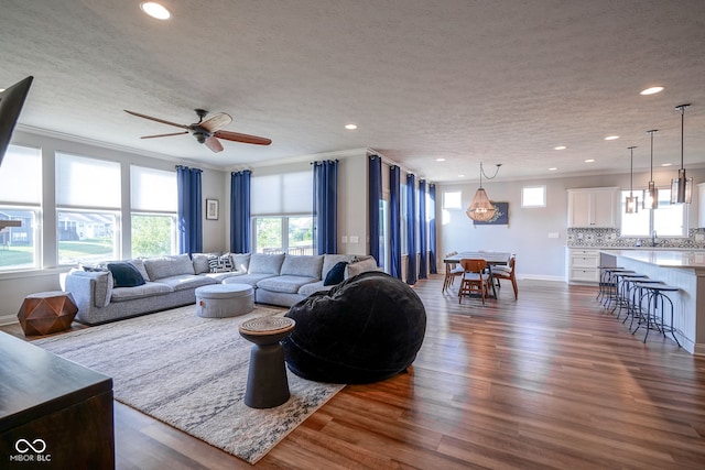 16235 Natures Way, Westfield, IN 46074 - living area featuring ornamental molding, recessed lighting, dark wood-type flooring, a textured ceiling, and ceiling fan