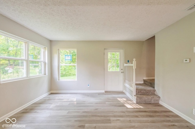 6570 N Private Road 525 E, North Vernon, IN 47265 - empty room with wood finished floors, a textured ceiling, and stairway