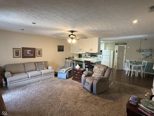 1001 Paradise Ct Unit F, Greenwood, IN 46143 - living room with dark colored carpet, a ceiling fan, and a textured ceiling