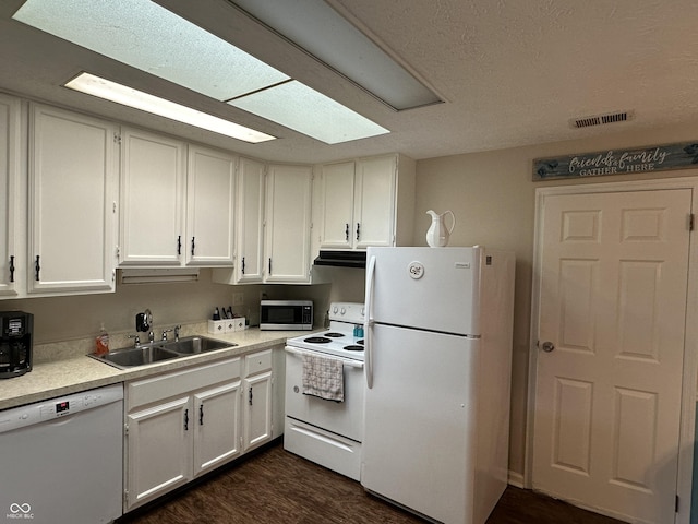 1001 Paradise Ct Unit F, Greenwood, IN 46143 - kitchen featuring white appliances, under cabinet range hood, dark wood-style floors, light countertops, and white cabinetry
