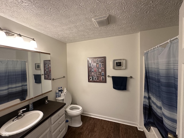 1001 Paradise Ct Unit F, Greenwood, IN 46143 - full bath featuring a textured ceiling, vanity, wood finished floors, and curtained shower