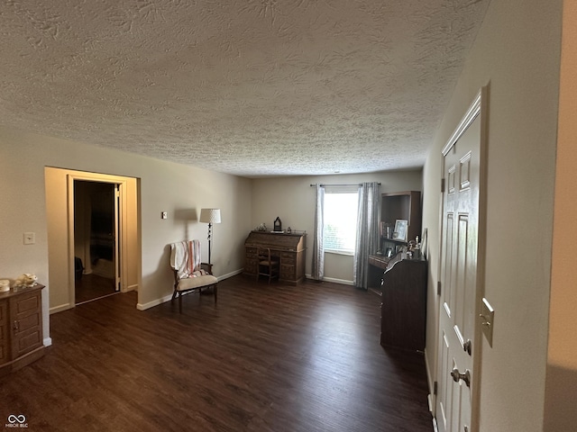 1001 Paradise Ct Unit F, Greenwood, IN 46143 - sitting room featuring a textured ceiling and dark wood-style floors