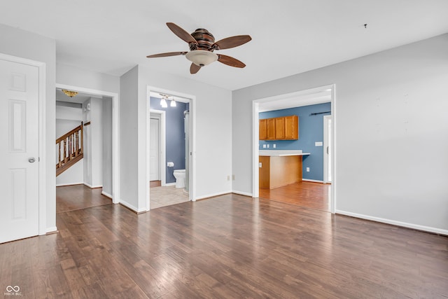 6329 Whitaker Farms Dr, Indianapolis, IN 46237 - unfurnished living room featuring ceiling fan, wood finished floors, and stairway