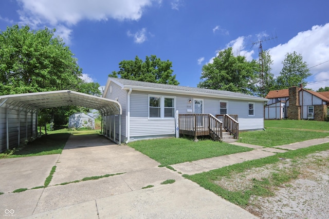1014 Washington St, Hope, IN 47246 - view of front of property with driveway, a front lawn, a carport, and a storage shed