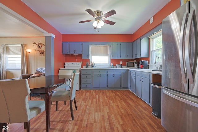 1014 Washington St, Hope, IN 47246 - kitchen featuring stainless steel appliances, washer / dryer, light countertops, and a ceiling fan