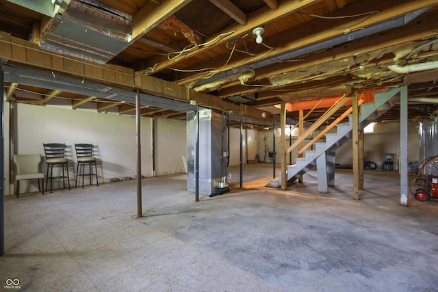 1014 Washington St, Hope, IN 47246 - unfinished basement featuring stairway and heating unit