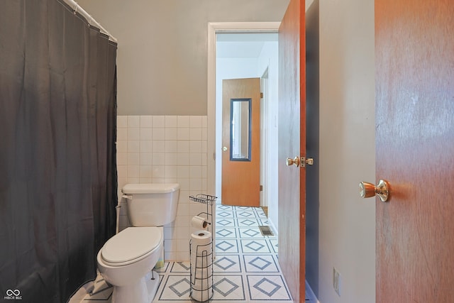 1014 Washington St, Hope, IN 47246 - bathroom with tile walls, tile patterned flooring, wainscoting, and a shower with curtain