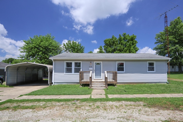 1014 Washington St, Hope, IN 47246 - view of front facade with a carport, concrete driveway, and a front lawn