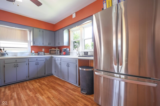 1014 Washington St, Hope, IN 47246 - kitchen with appliances with stainless steel finishes, light wood-style floors, gray cabinetry, light countertops, and a ceiling fan