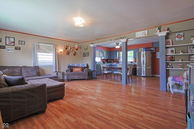 1014 Washington St, Hope, IN 47246 - living area featuring light wood-style floors, ceiling fan, and ornamental molding