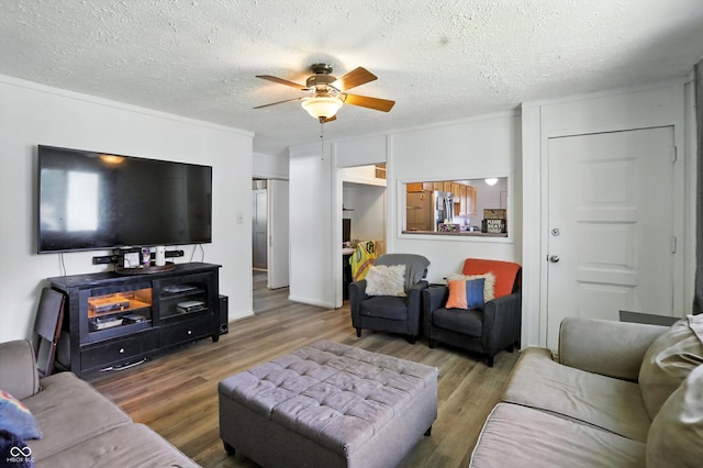 7307 Twin Beech Dr, Indianapolis, IN 46226 - living room featuring ceiling fan, wood finished floors, and a textured ceiling