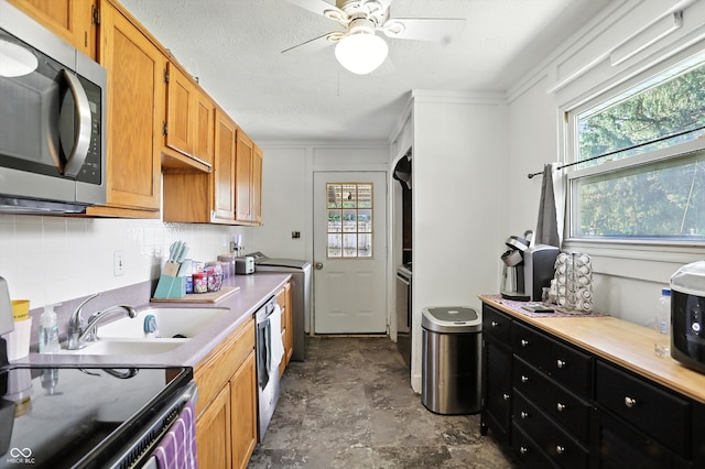7307 Twin Beech Dr, Indianapolis, IN 46226 - kitchen featuring stainless steel microwave, plenty of natural light, tasteful backsplash, stone finish flooring, and ornamental molding