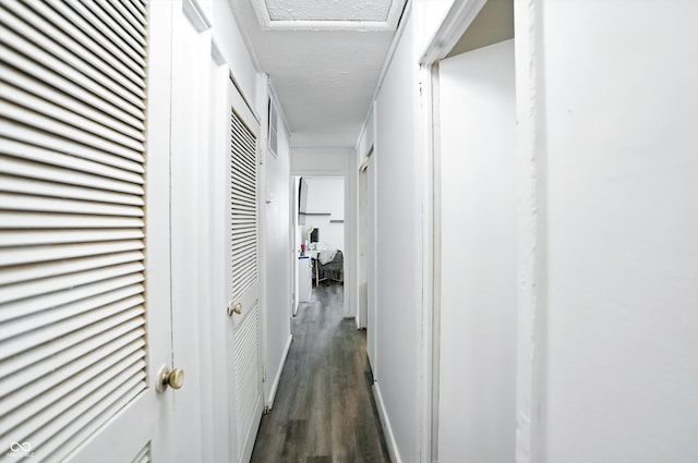 7307 Twin Beech Dr, Indianapolis, IN 46226 - hallway featuring dark wood-style floors and a textured ceiling