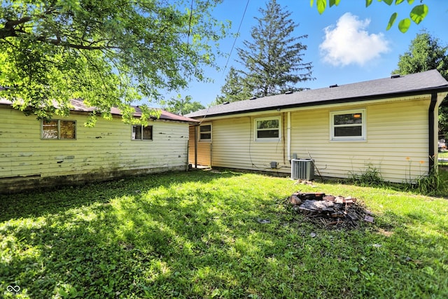 7307 Twin Beech Dr, Indianapolis, IN 46226 - back of house with a lawn and an outdoor fire pit
