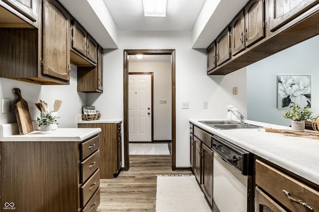 2247 Frisco Pl, Indianapolis, IN 46240 - kitchen featuring dishwasher, light wood-style floors, light countertops, and dark brown cabinetry