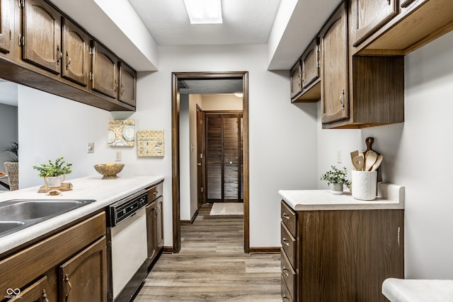2247 Frisco Pl, Indianapolis, IN 46240 - kitchen featuring white dishwasher, light wood-style flooring, light countertops, and dark brown cabinets