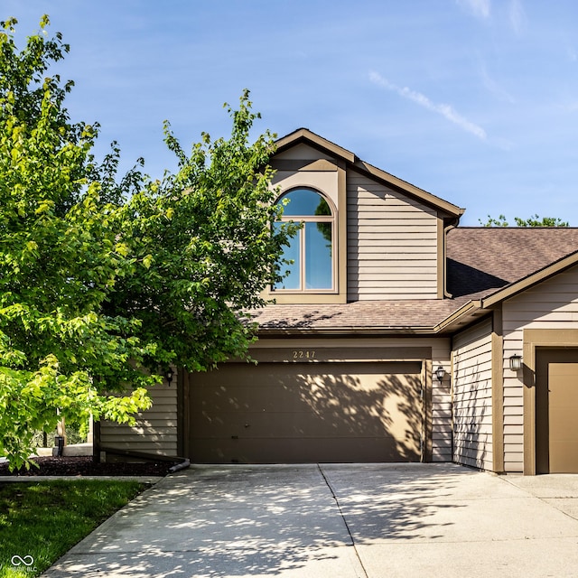 2247 Frisco Pl, Indianapolis, IN 46240 - view of front of house featuring driveway, a garage, and roof with shingles