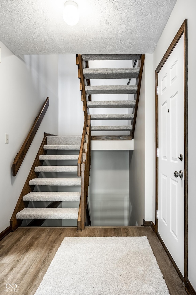 2247 Frisco Pl, Indianapolis, IN 46240 - stairs with a textured ceiling and wood finished floors
